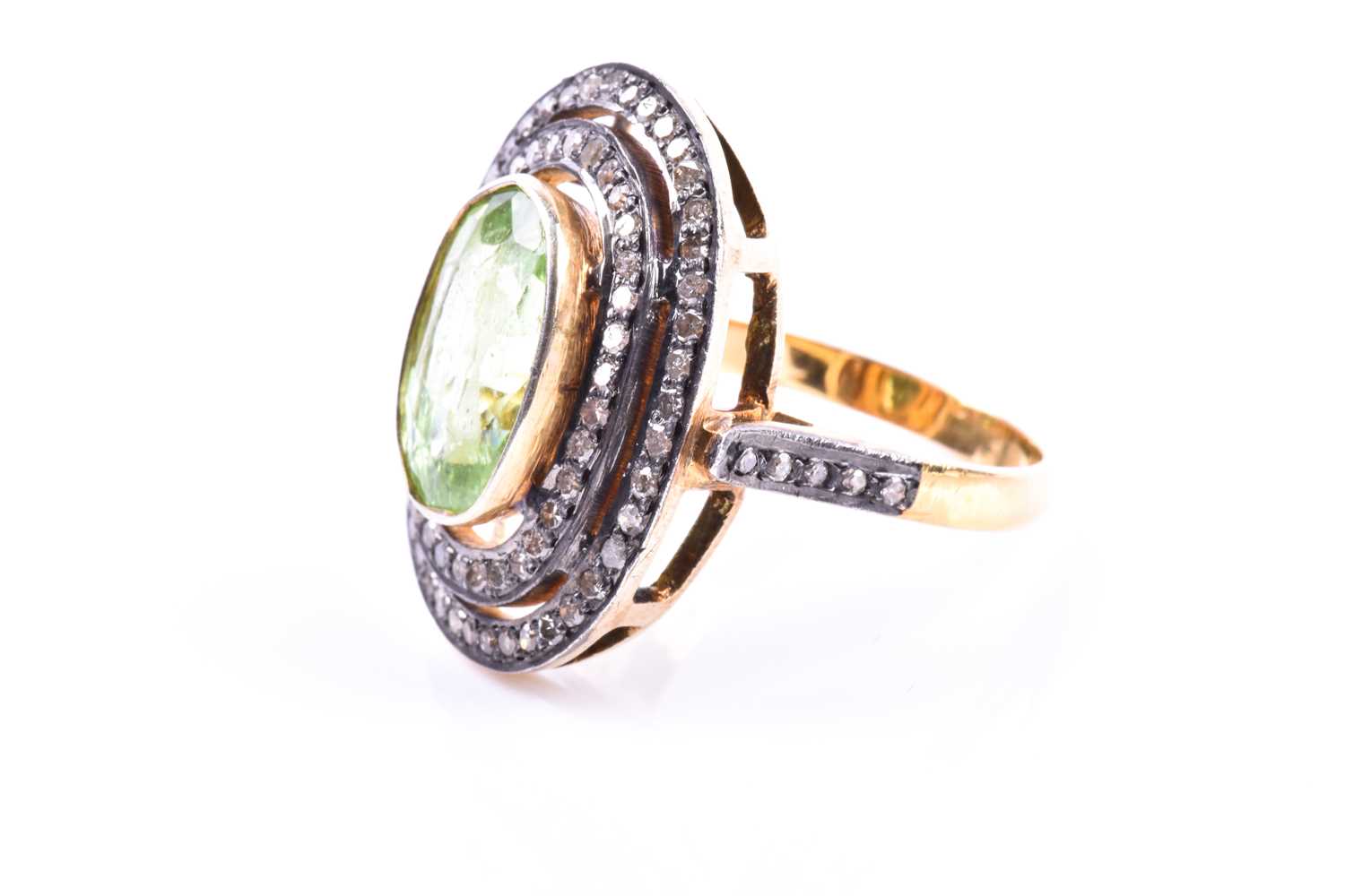 A silver gilt, peridot, and diamond cocktail ring, the silver gilt mount set with a mixed oval-cut - Image 4 of 4