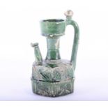 An Islamic green glazed earthenware ewer, possibly Ommayad, the neck with generous mouth above the