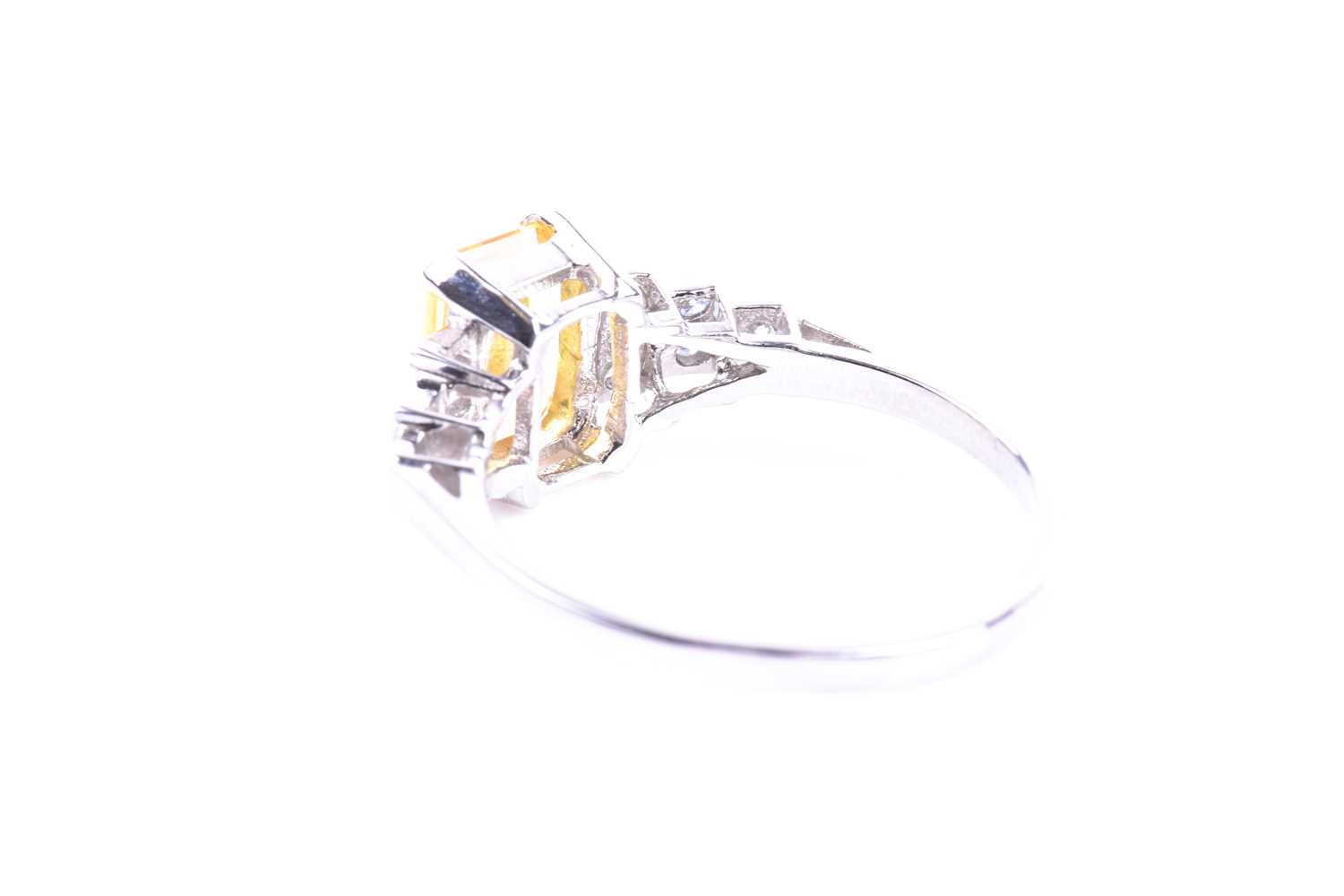 A platinum, diamond, and yellow sapphire ring set with a mixed emerald-cut yellow sapphire of - Image 4 of 4