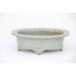 A Chinese celadon jardiniere, 中国，青瓷花盆一件，20世纪 20th century, the flat rim and deep well with a grey/