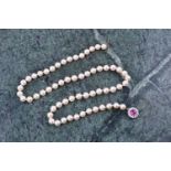 A cultured pearl necklace, individually knotted pearls, approximately 6 mm diameter, fastened with a