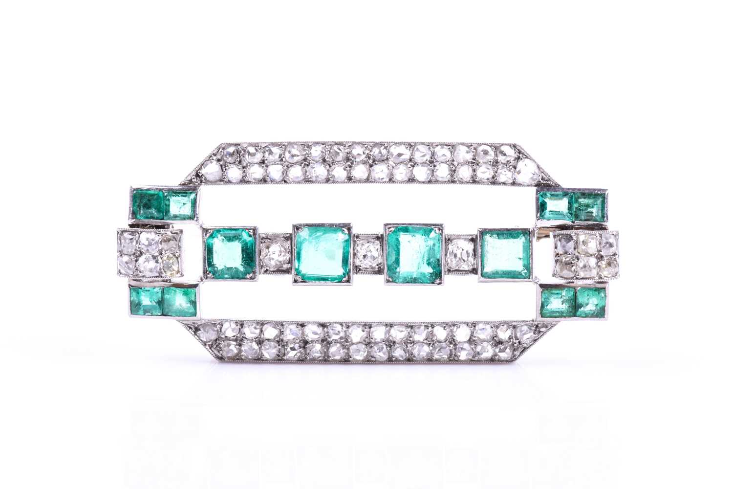 An Art Deco diamond and emerald broochthe rectangular mount inset with twelve emeralds (likely of