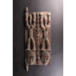 A Baule attributed carved wood granary door, made up of two matching panels united by natural