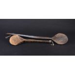 Two African carved wood spoons, each with geometric carved decoration, the smaller spoon carved to