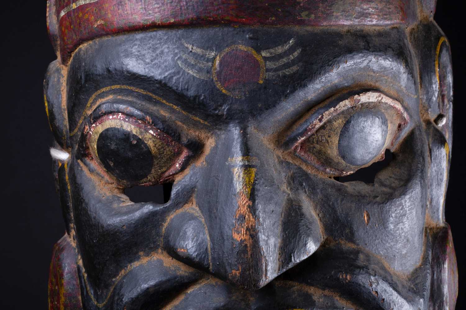 An Indonesian carved and painted ceremonial male mask, in yellow, red, white and black pigment, - Image 2 of 5