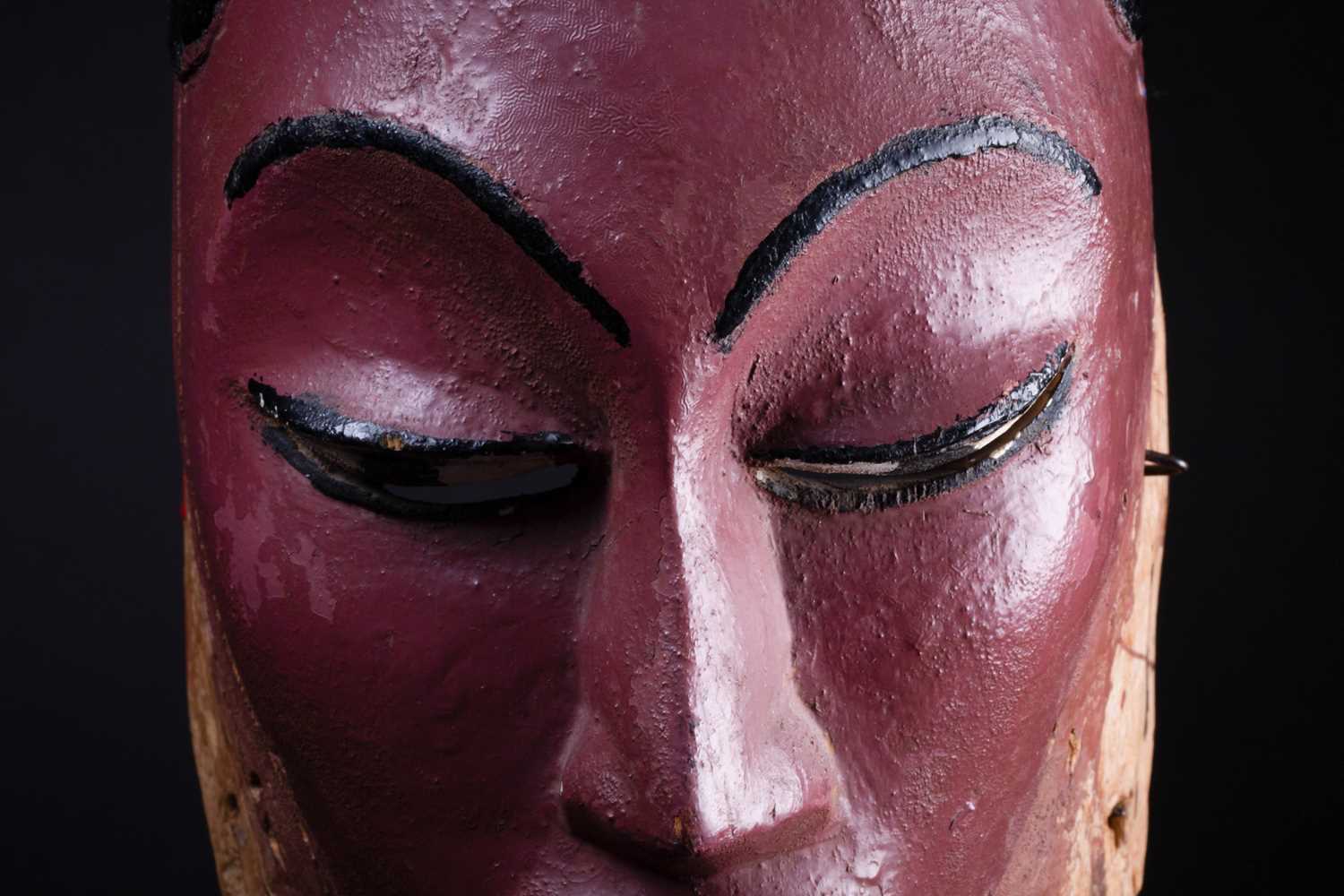A Colon mask, Nigeria, the female mask painted in polychrome, surmounted by a car with a standing - Image 3 of 7