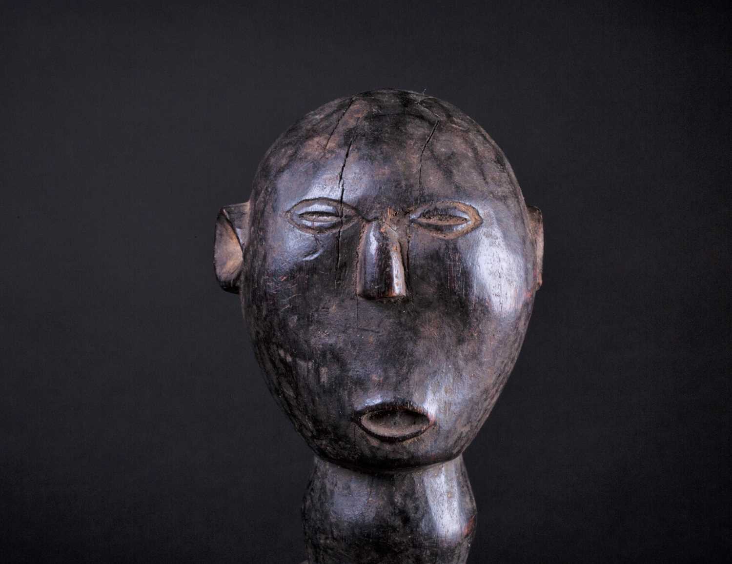 An East African carved wood standing figure of a man, Possibly Kamba, Kenya, his hands resting - Image 2 of 5