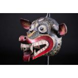 A Barong mask, Bali, Indonesia, hand carved and painted in black, red, white and yellow, pierced