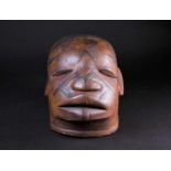A Maconde Lipiko mask, Mozambique, carved with scarification marks, 24cm high, approximately 32cm