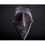 A Lwalwa mask, Democratic Republic of Congo, with cross hatched coiffure, rectangular eyes and