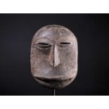 A Hembe mask, Democratic Republic of Congo, painted in a thick dark pigment, 25cmFootnote: From