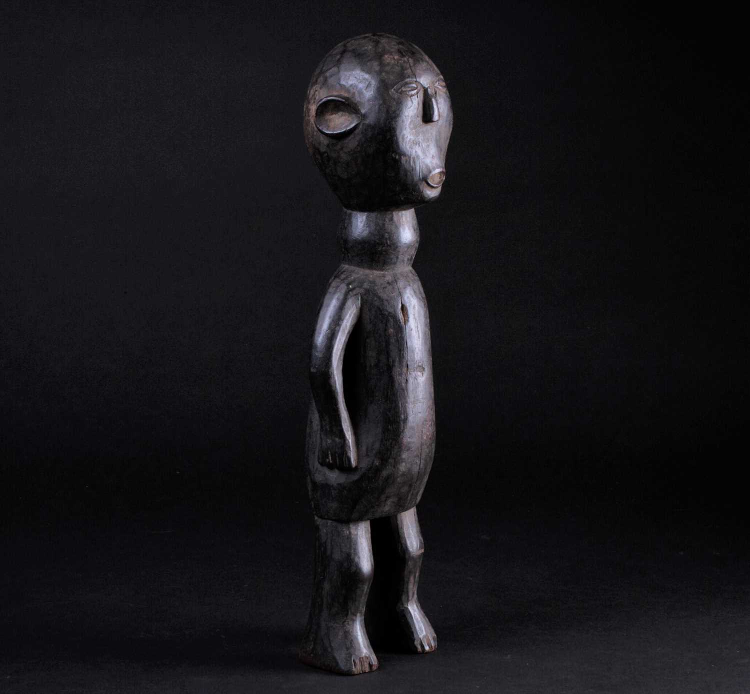 An East African carved wood standing figure of a man, Possibly Kamba, Kenya, his hands resting - Image 5 of 5
