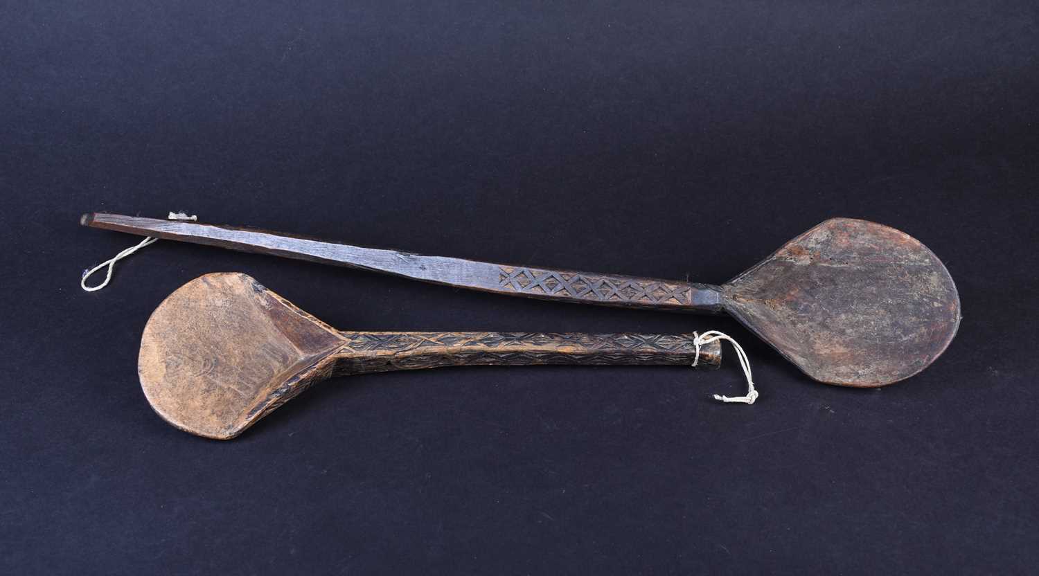 Two African carved wood spoons, each with geometric carved decoration, the smaller spoon carved to - Image 5 of 17