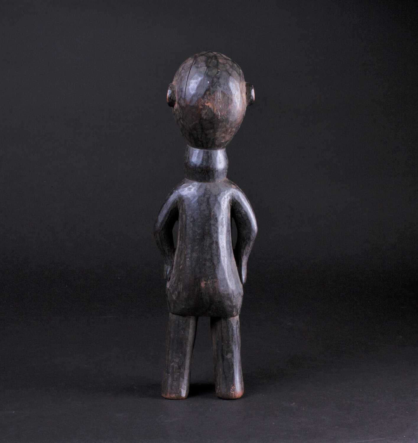 An East African carved wood standing figure of a man, Possibly Kamba, Kenya, his hands resting - Image 4 of 5