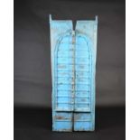 A pair of North African painted wood window shutters, of rectangular form with applied arched