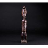 A Baule Blolo Bian standing figure, Ivory Coast, with fine lineated coiffure and a short beard,