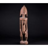 A Dogon hermaphrodite standing figure, Mali, with pointed coiffure, scarification marks to head,