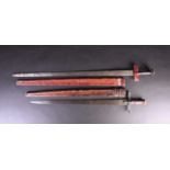 Two Sudanese Tuareg Takouba swords, the smaller sword with leather pommel, reptile skin grip and
