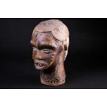 An Idoma Janus mask headdress, Nigeria, one face kaolin painted, the other covered in animal skin,