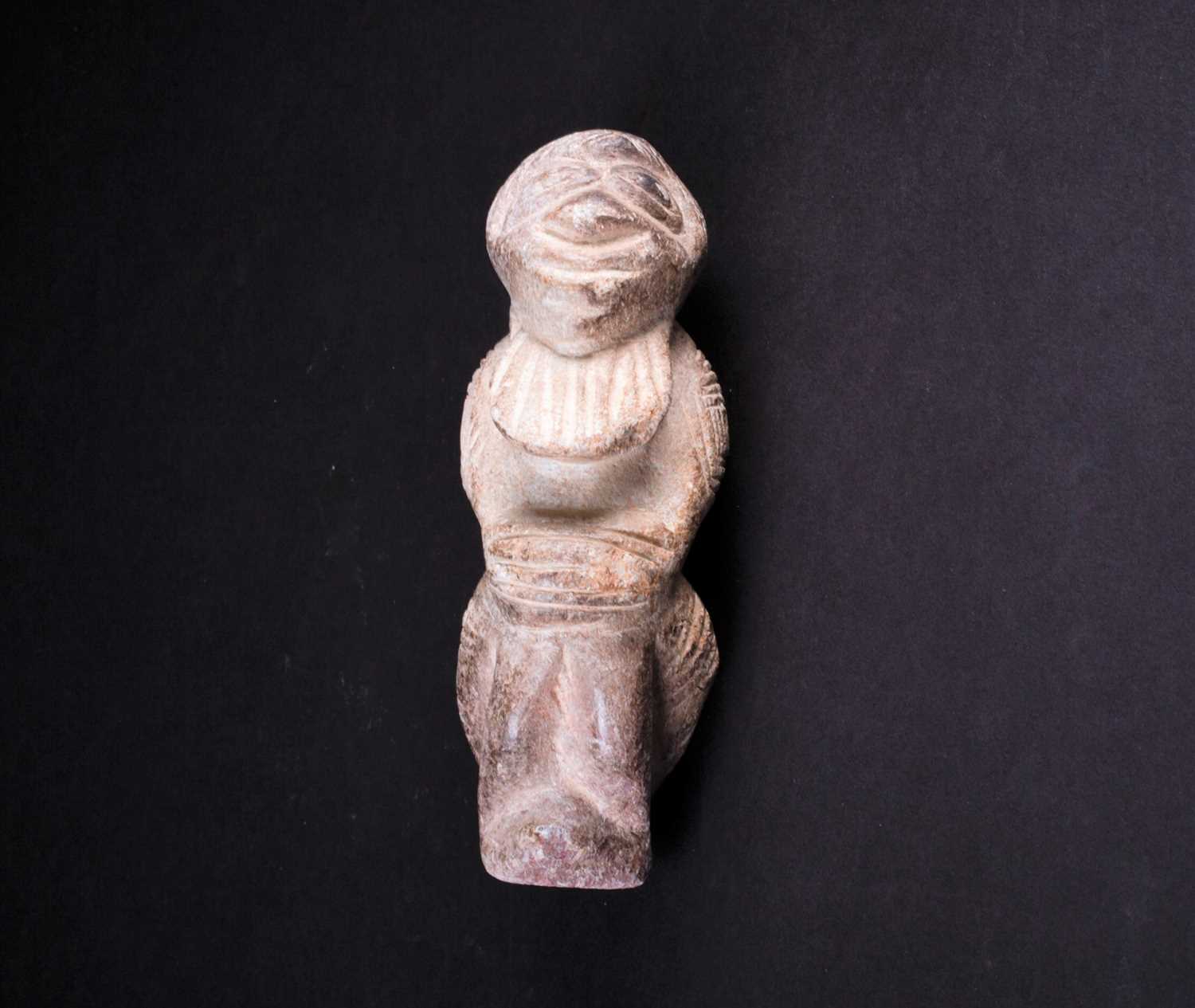 A carved stone Nomoli figure, Sierra Leone, with incised linear decoration, 17cmFootnote: From the