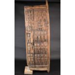 A Dogon carved wood door, Mali, carved with ancestral figures, 159cm x 56cm (excluding housing