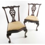 A pair of George III carved and pieced mahogany "Chippendale" style side chairs with bow-shaped