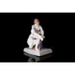 A late 19th century Russian Gardner Porcelain figure, a female semi-clothed and sitting on a