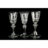 A pair of 18th Continental stemmed wine glasses with wheel etched figures in rural landscapes to the