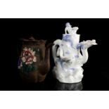 A Japanese Meiji period Hirado porcelain wine pot in the form of a dragon protruding from a rock