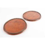 A pair of Victorian circular, mahogany trays each with a pierced gilt metal gallery. 26cm diam.