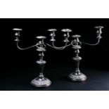 A pair of silver-plated three-sconce candelabrum, with scrolled arms and relief decoration, 38 cm