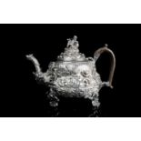 A fine George III silver teapot, London 1817 by Edward Farrell, the chased and embossed decoration