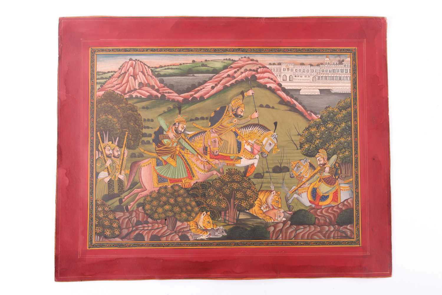 An Indian Mughal style watercolour depicting a tiger hunting scene with men on horseback with lances