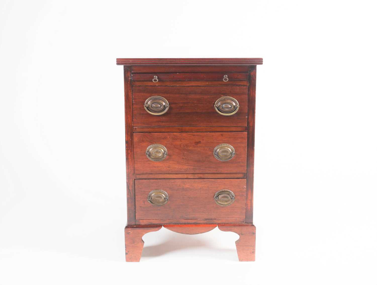 A small Geo III style mahogany chest of three short drawers with brushing slide above. Raised on