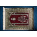 A 20th century finely knotted Turkish (possibly Hereke) prayer rug with lobed mihrab with the