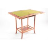 A 19th century bamboo and painted lacquer fold-over gaming table with under tier. Raised on slightly