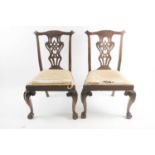 A pair of Geo III carved and pieced mahogany "Chippendale" style side chairs with bow-shaped