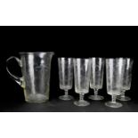 A 20th century etched glass water jug and five conforming glasses, the jug 21 cm high.