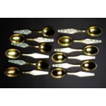A set of twelve Danish silver gilt spoons of Modernist design, with snowflake pattern to the handle,