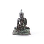 A probably Northern Indian bronze figure of a seated Buddha in the Bhumisparsa Mudra upon a lotus