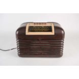 A bakelite Bush Radio, mid 20th century, serial number 62/22130, 24 cm high x 32 cm wide.