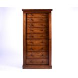 A Victorian figured mahogany, pedestal "Wellington" chest with Nine short drawers locked by a single