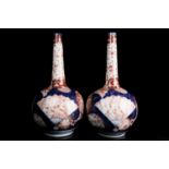 A pair of 19th century Japanese Meiji, Imari, bottle vases painted in fan and circular reserves of