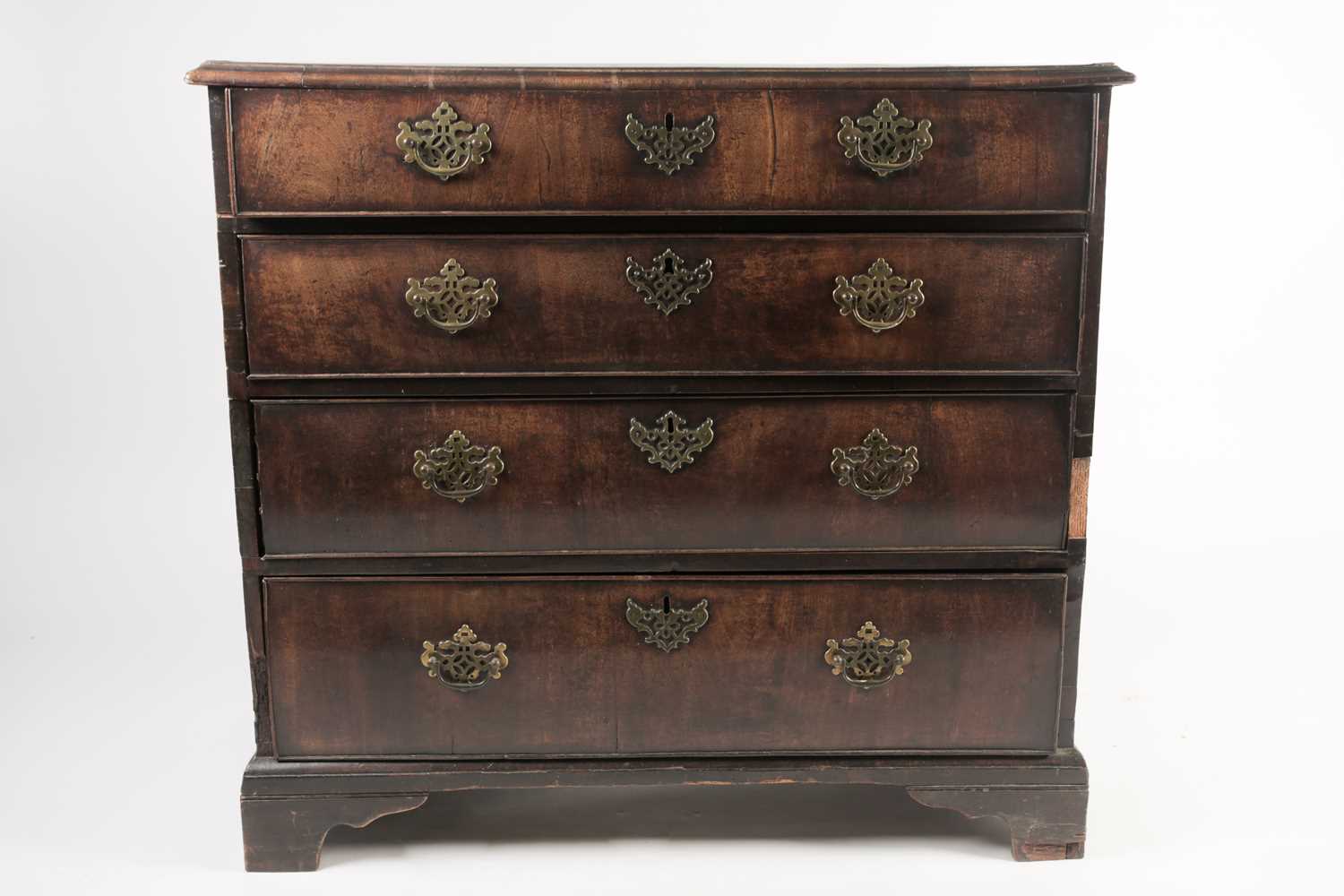 A late George II red walnut veneered chest of drawers, with broad crossbanded top above four