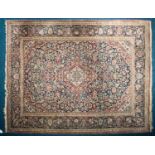 A 20th century Kerman rug with "Bookcover" scheme on a dark blue ground of many colorful flowers