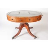 A George III circular satinwood and strung mahogany drum library table, with tooled leather inset