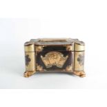 A 19th century black lacquer tea caddy, of lobed form with chinoiserie gilt decoration on four paw