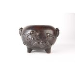 A Japanese bronze tripod censer, Meiji period, decorated with bats in relief bearing two