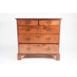 An early 18th century walnut chest of drawers with crossbanded quarter veneered above Two short over