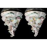 A pair of 19th c. Austrian, Vienna porcelain wall brackets with flower, scroll, and winged putto